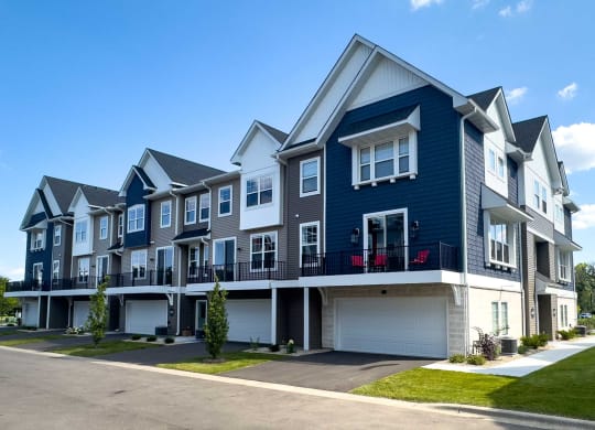 a row of blue and white townhomes on a street