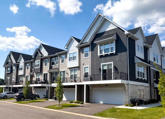 a row of town houses with balconies and a street