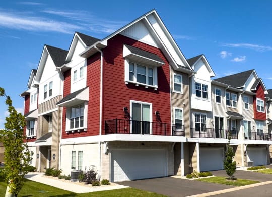 a row of town houses with red and white exterior