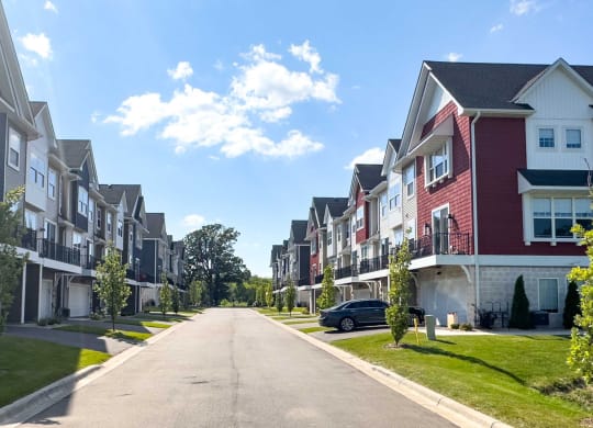 a row of townhomes on the side of a street
