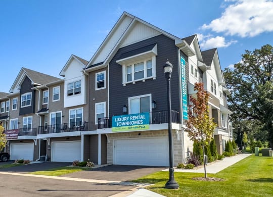 a townhome community with a street sign in front of it