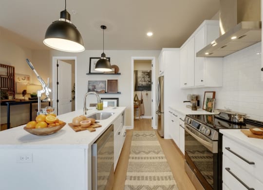 a large kitchen with white cabinets and a counter top