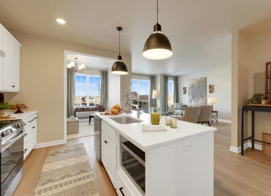 an open kitchen and living room with a white counter top