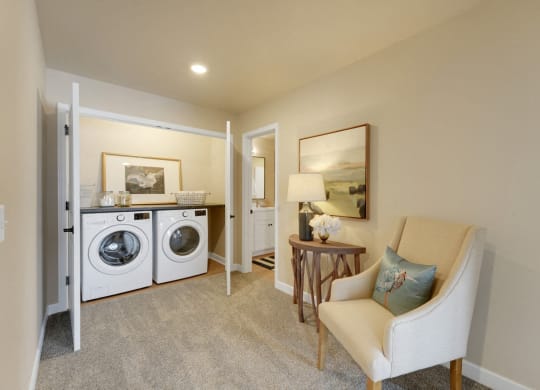 a living room with a washing machine and a dryer in it