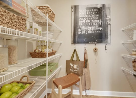 a walk in closet with a chalkboard and a chair