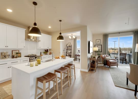a kitchen and living room with a white counter top