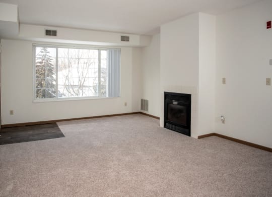 Living room with fireplace in select homes