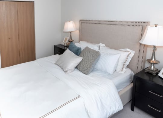 a bedroom with a bed and two nightstands
