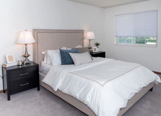 a bedroom with a bed and two nightstands