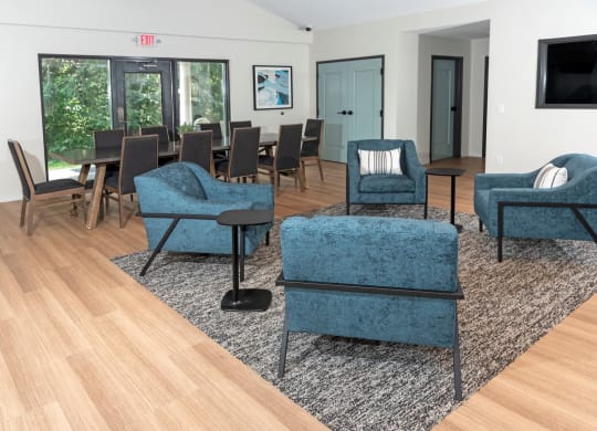 a living room filled with furniture and a large window