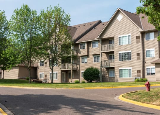 a large apartment building with a fire hydrant in front of it
