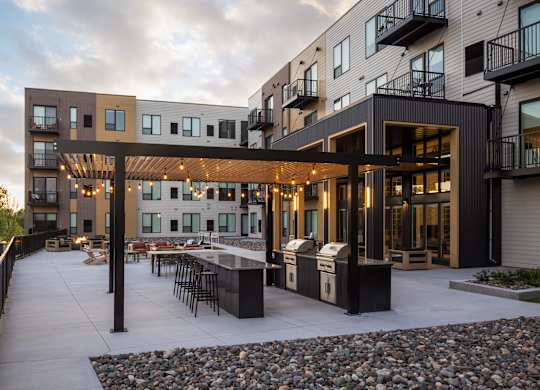 A modern building with a patio and a fire pit.