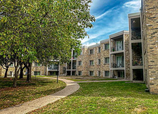 A modern building with a brick facade and a pathway leading to it.