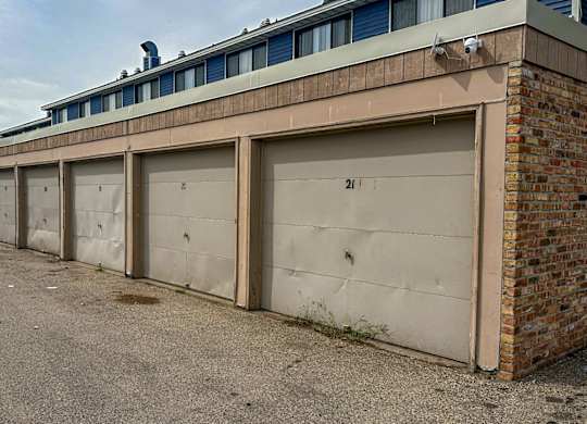 A long row of garage doors are closed.