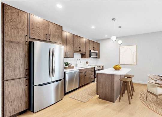 A modern kitchen with wooden cabinets and stainless steel appliances.