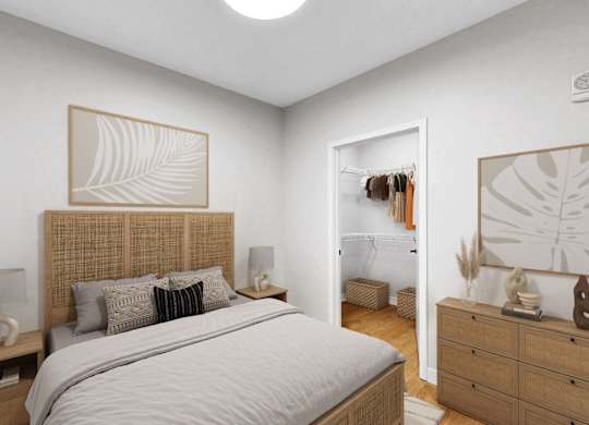 A bedroom with a large bed, a nightstand, and a dresser with a mirror.