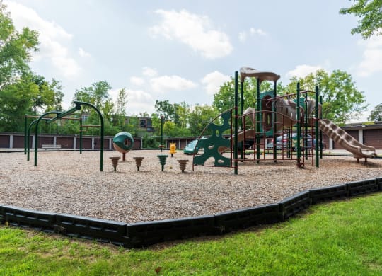 a playground with a climbing structure and picnic tables