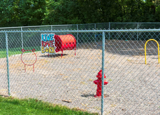 a red fire hydrant sitting in the middle of a field