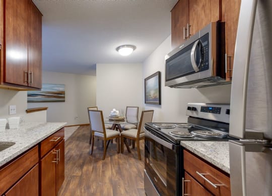 a kitchen with wooden cabinets and granite countertops