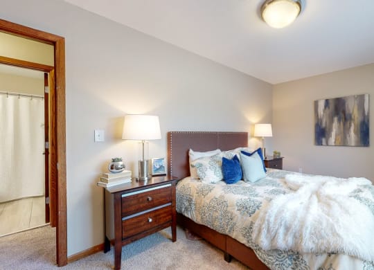 a bedroom with a bed and two night stands