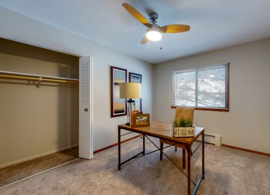 a living room with a ceiling fan and a window