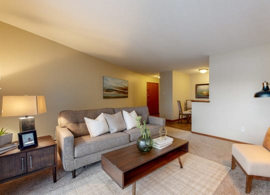 a living room with a gray couch and a wooden coffee table