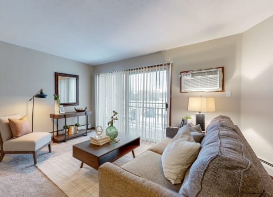 a living room with a couch chair and coffee table