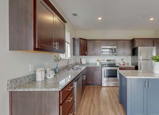 A kitchen with brown cabinets and a granite countertop. at Lake Jonathan Flats, Minnesota, 55318