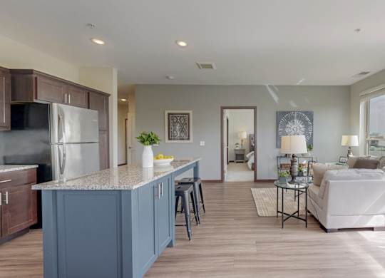 A modern kitchen with a blue island and white appliances. at Lake Jonathan Flats, Minnesota, 55318
