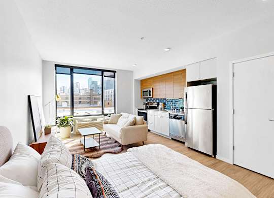 A modern living room with a large window overlooking the city.