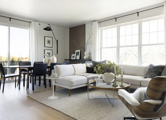 a living room with a white couch and a dining room table