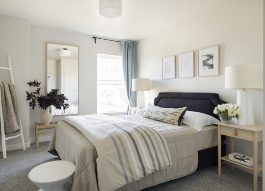 a bedroom with a bed and a mirror and a bathroom