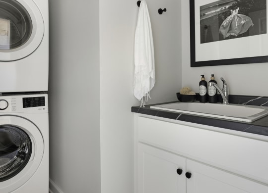 a small laundry room with a washing machine and a sink