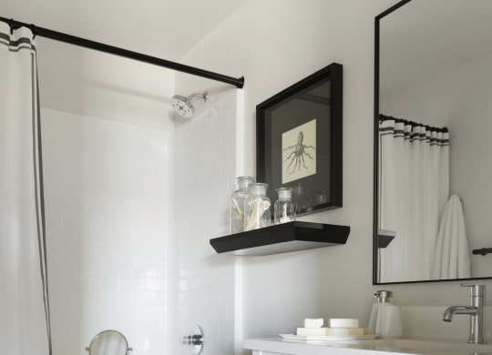 a white bathroom with a white toilet and a sink