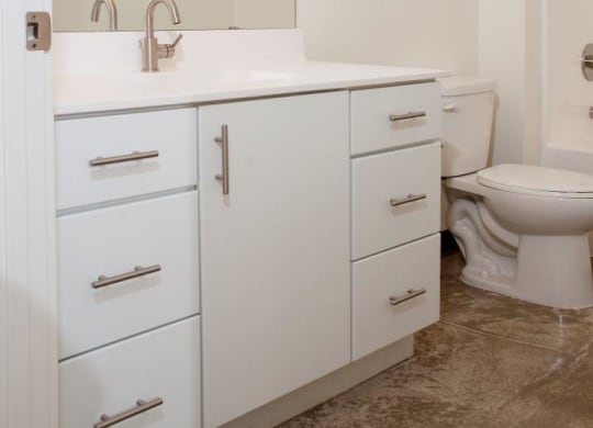 Spacious Bathroom with White Cabinetry and Silver Hardware at 700 Central Apartments, Minnesota, 55414
