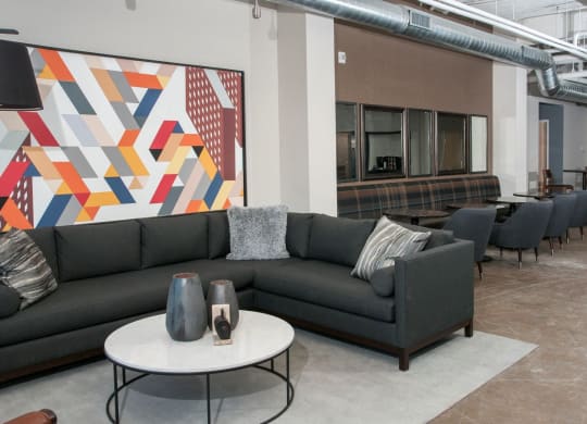 Large Industrial Style Lobby with Various Couches and Colorful Art at 700 Central Apartments in Minneapolis, MN