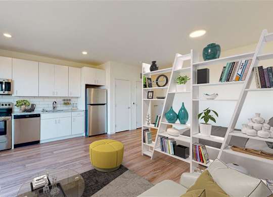 A modern kitchen with a dining table and a bookshelf at The Bessemer at Seward Commons Apartments, Minneapolis, MN,  55404