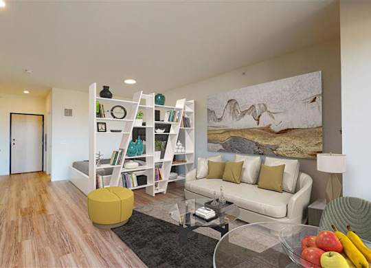 A modern living room with a white couch and a painting on the wall at The Bessemer at Seward Commons Apartments, Minneapolis, Minnesota