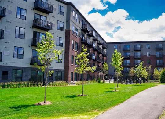 Apartment buildings with green lawns in front at The Bessemer at Seward Commons Apartments, Minnesota, 55404