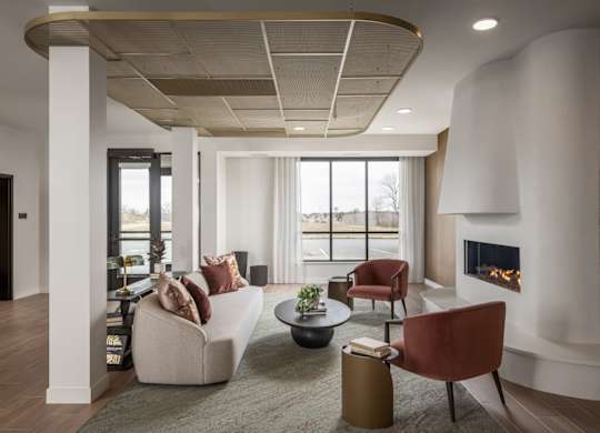 A modern living room with a fireplace and a large window.