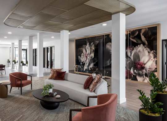 A modern living room with a large painting on the wall.