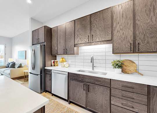 A kitchen with wooden cabinets and a white countertop.