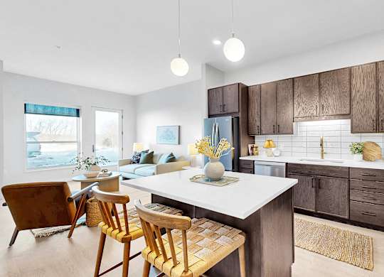A modern kitchen with wooden cabinets and a white island.