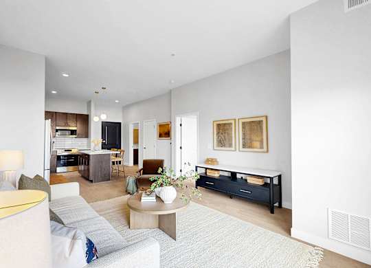 A modern living room with a white sofa and a coffee table.