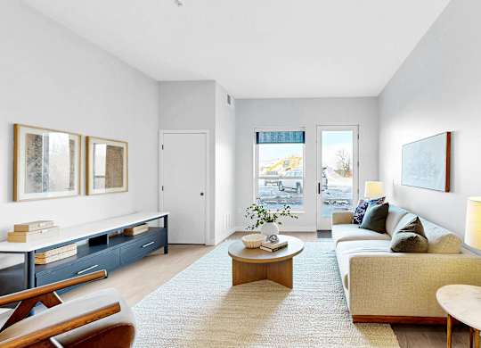 A living room with a couch, a coffee table, and a lamp.