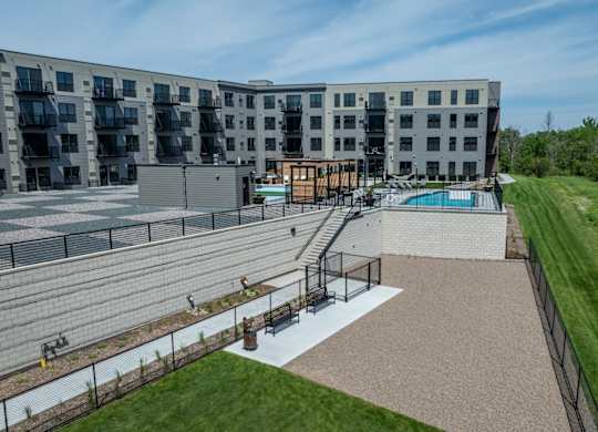 A large apartment complex with a pool and a playground.