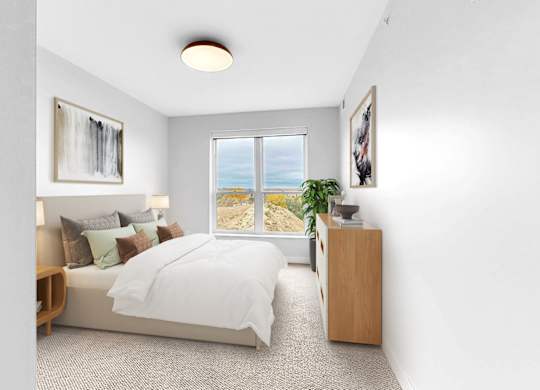 A bedroom with a large bed, a window with a view, and a wooden nightstand.
