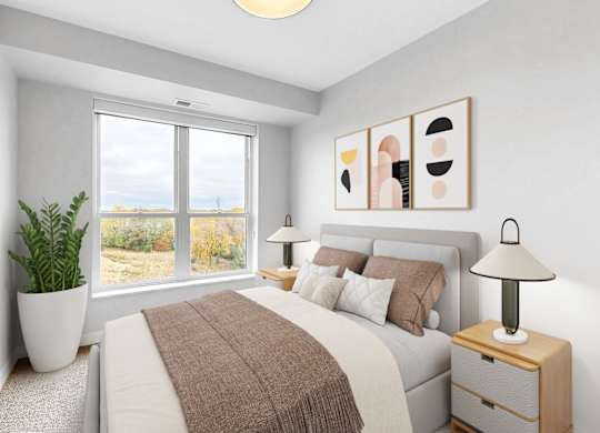 A bedroom with a large bed, a potted plant, and a lamp.