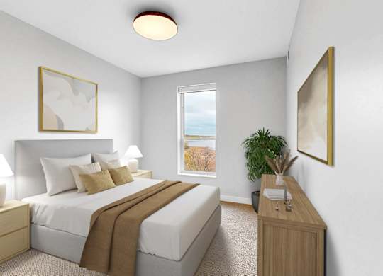 A bedroom with a large bed and a window overlooking a beach.