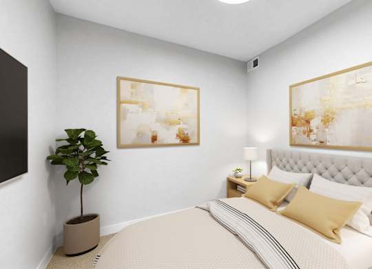 A bedroom with a large bed, a potted plant, and two framed artworks on the wall.